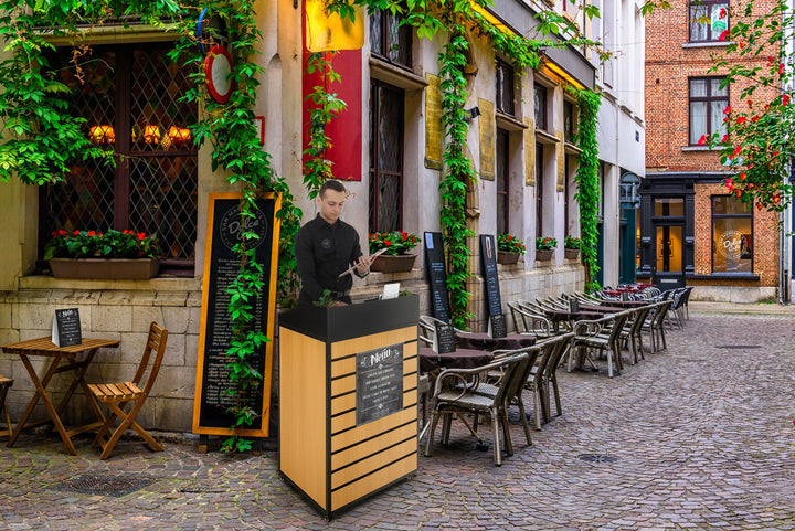 24" Host Station with Slatwall Front and Locking Casters, outside a cafe