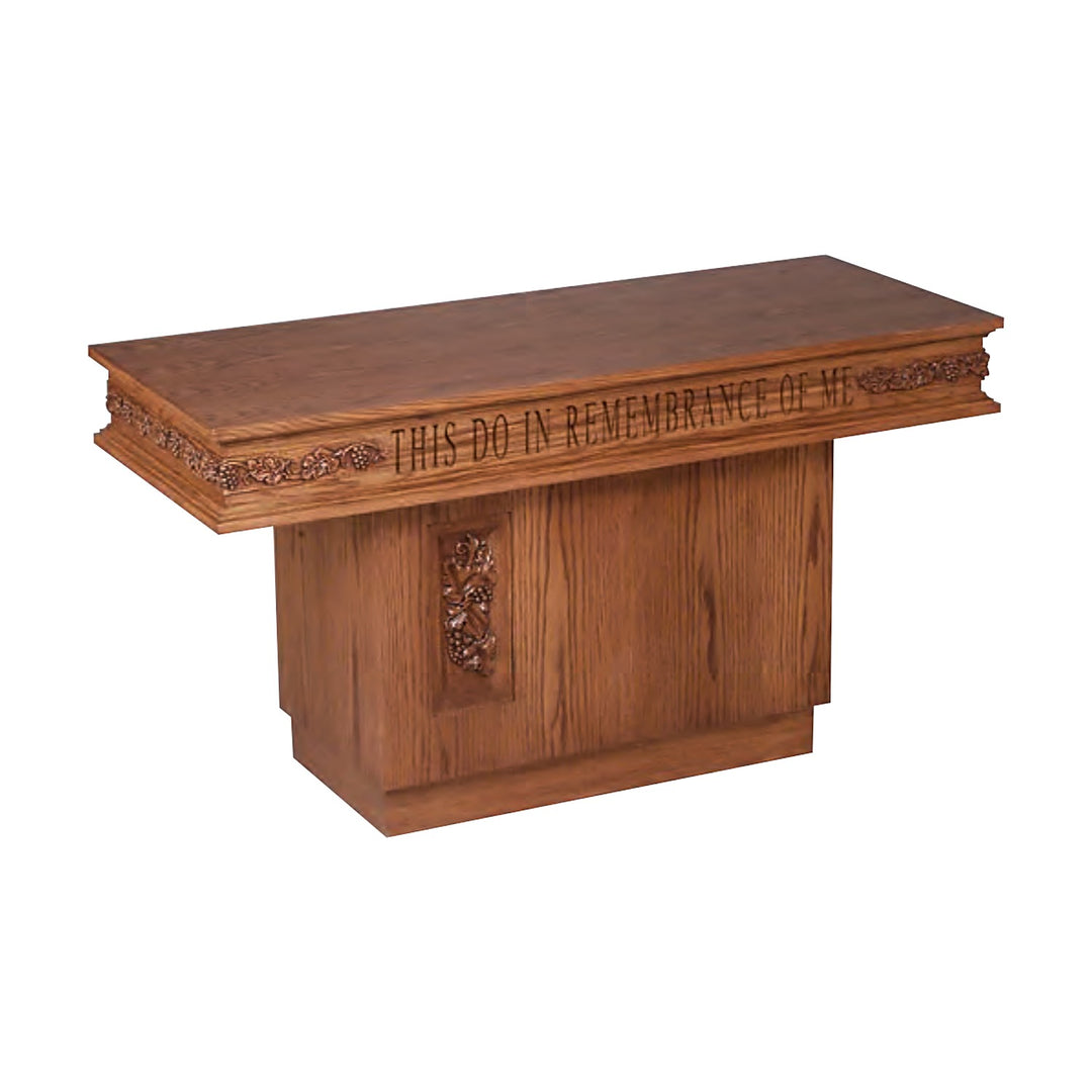 NO 560 pedestal communion table in solid red oak with carved grapevine trim and inscription