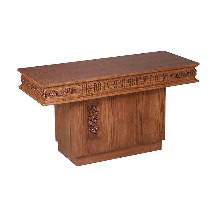 NO 560 pedestal communion table in solid red oak with carved grapevine trim and inscription