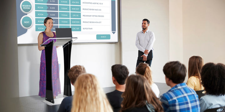 Portable Knock-Down Acrylic Lectern with Black Side Panels, in a meeting room