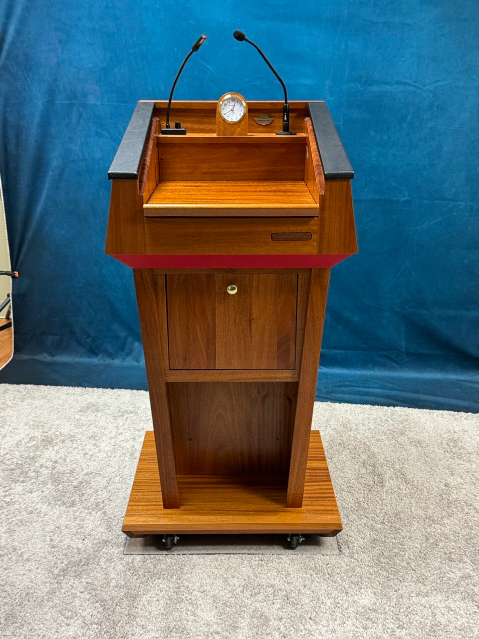 wooden podium with sound system microphone speakers clock