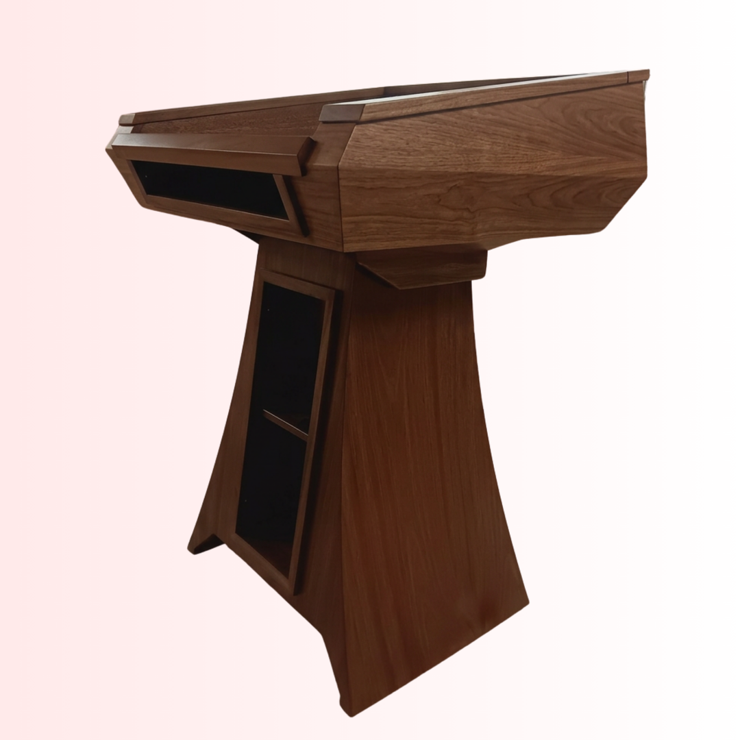 A modern wooden podium with a rich walnut-like finish, featuring a slanted top, integrated side storage compartments, and a tapered pedestal base, shown against a light pink gradient background.